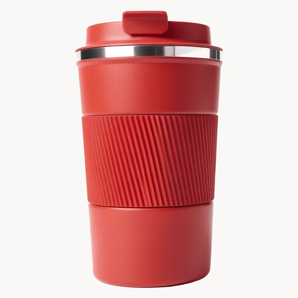 Red travel coffee mug with ribbed grip and lid, ideal for on-the-go use