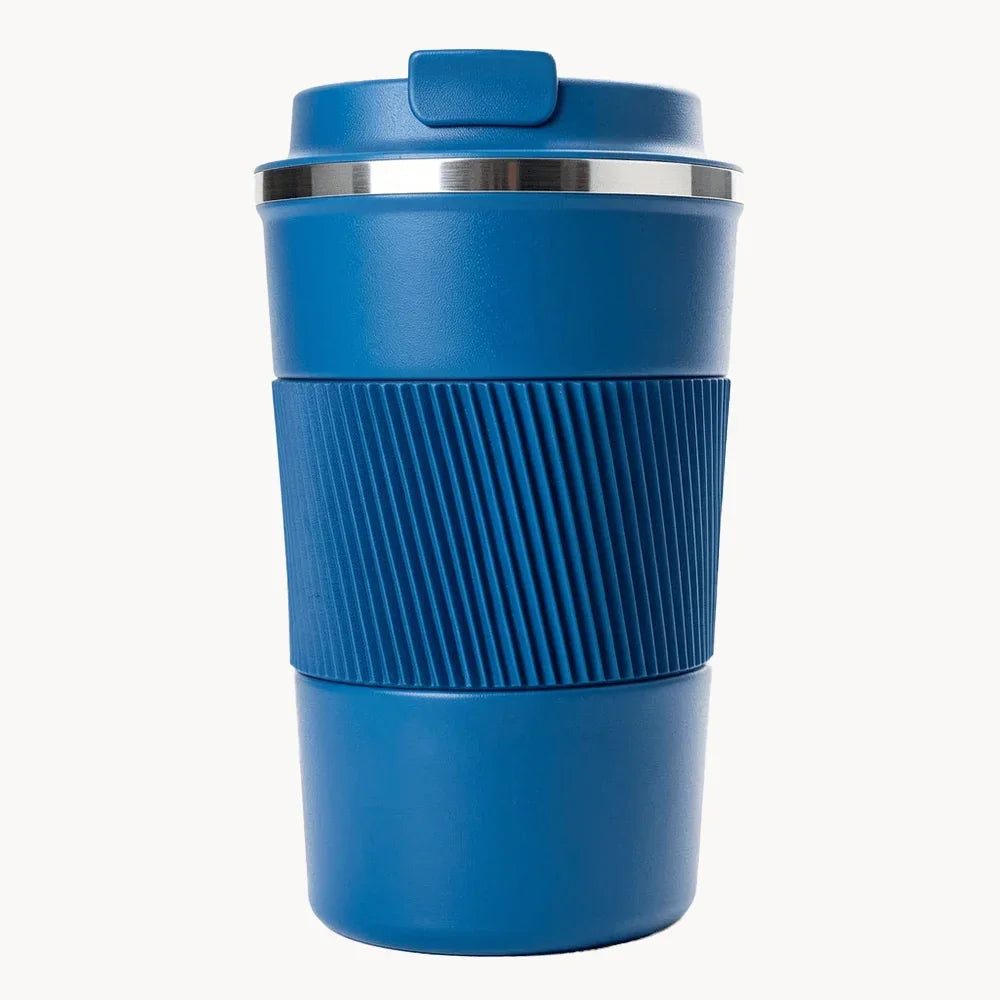 Blue travel coffee mug with ribbed grip and lid, ideal for on-the-go use