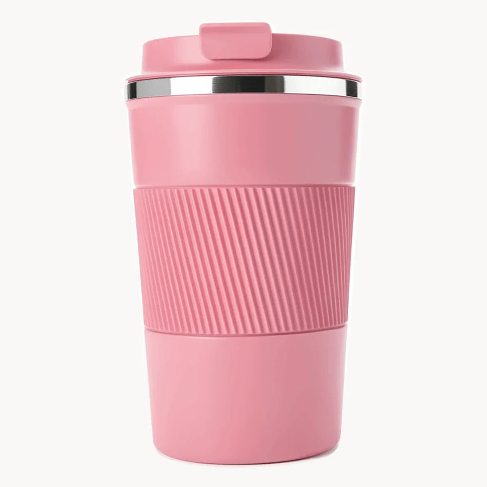 Pink travel coffee mug with ribbed grip and lid, ideal for on-the-go use